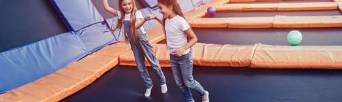 Children playing at an indoor trampoline and adventure park