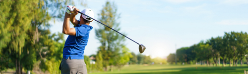 Golfer teeing off on a scenic Ozarks golf course near Branson, Missouri