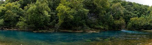 Clear spring-fed river surrounded by forest at Roaring River State Park in Missouri